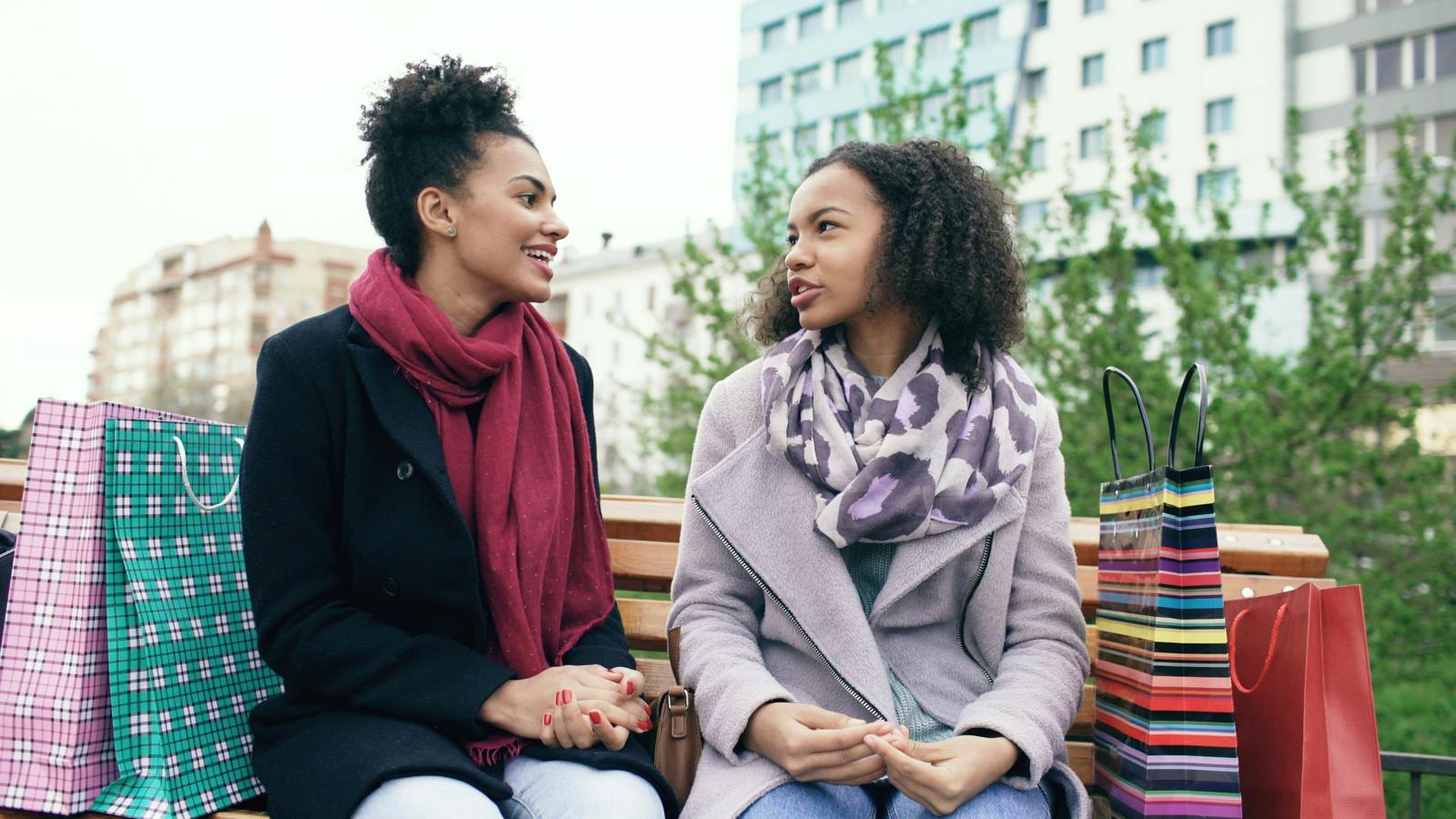 Two women in winter coats chatting outdoors