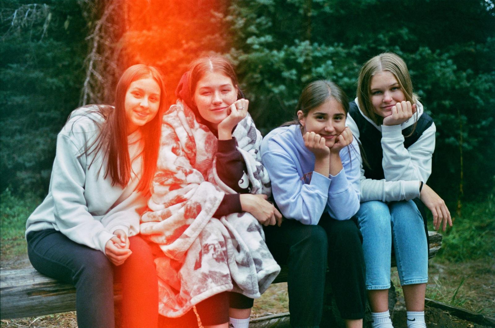 Girls Corner: teenage girls sitting together outdoors