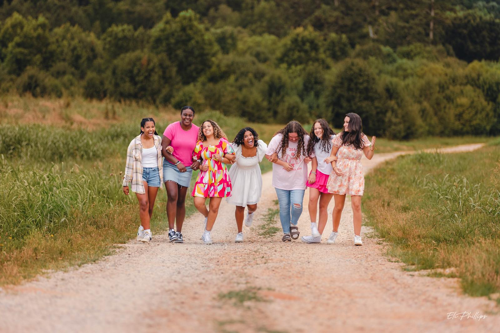 A group of young women walking together along a country path