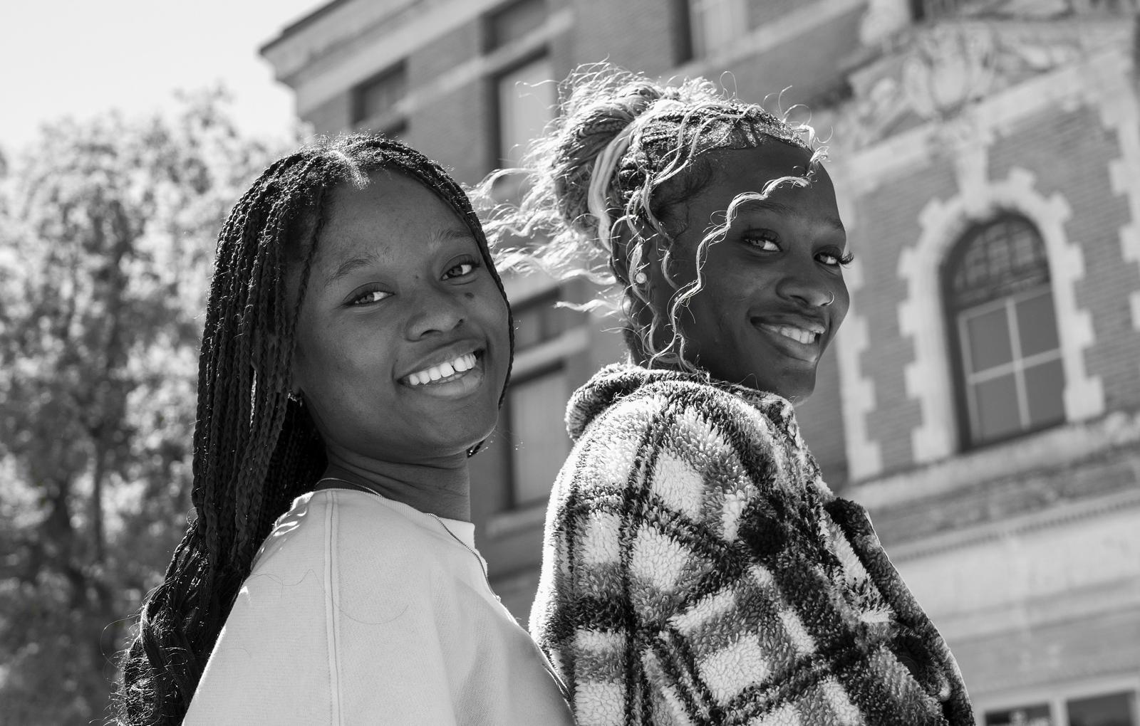 Black-and-white portrait of two smiling young women